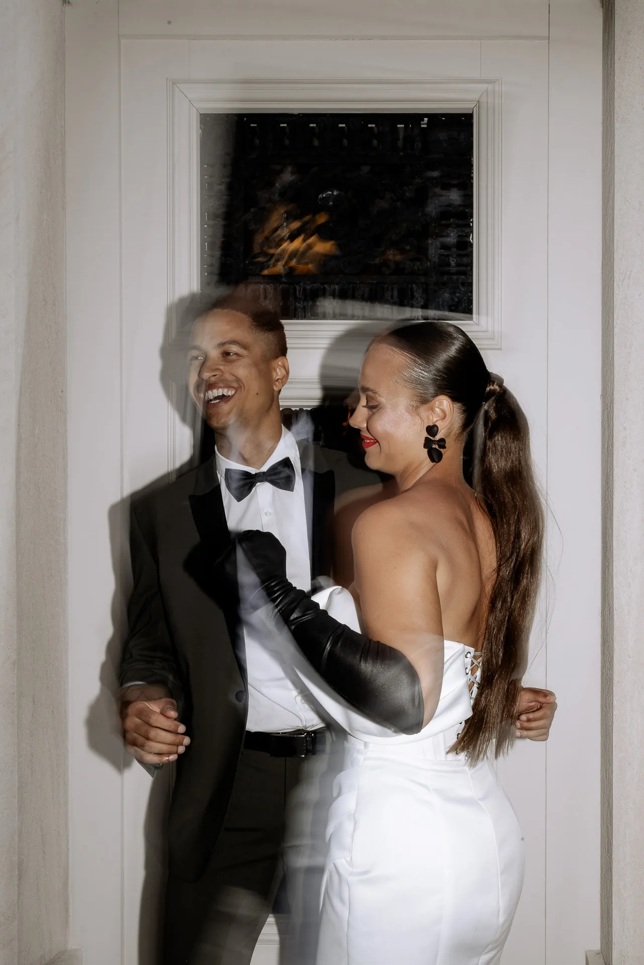 Joyful laughing bridal couple in intimate embrace at Chateau de Varennes with authentic atmosphere